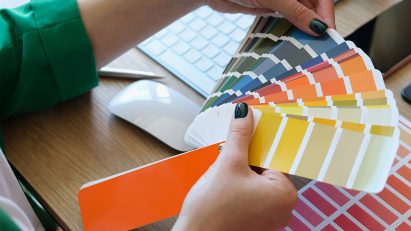 A person looking at a colour chart fan