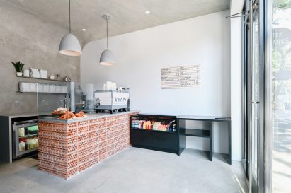 Brick cafe counter facing a glass facade