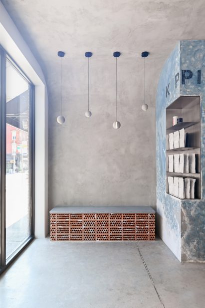 Concrete interior with small brick bench against a wall