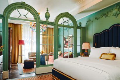 Green classical screen separates bedroom spaces