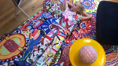Alf Bärbel Wit lying on a LinesLinesLines rug