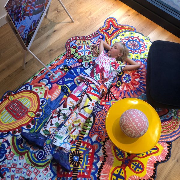 Alf Bärbel Wit lying on a LinesLinesLines rug