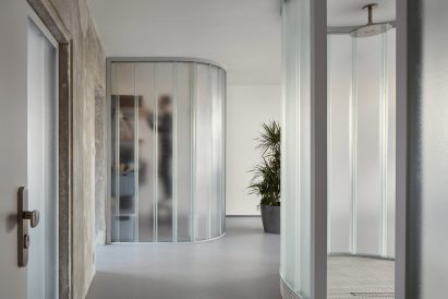 Neuhäusl Hunal renovate apartment in Prague using curved glass partitions