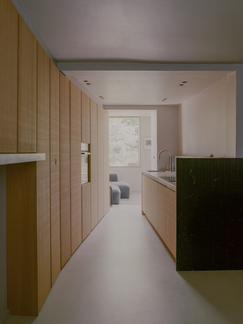 Kitchen with concrete flooring and wood wall cupboards