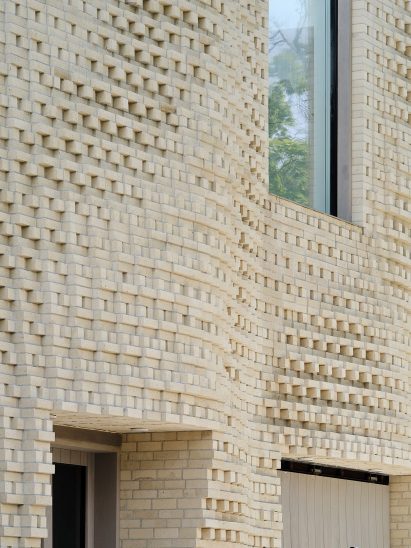 Pixellated brick facade with rectilinear windows