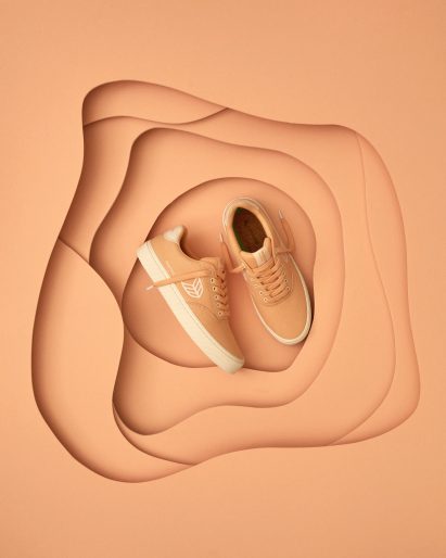 Peach-coloured trainers against a Peach Fuzz backdrop