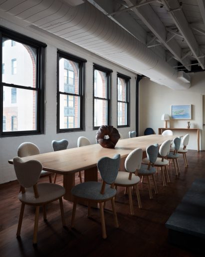 Long dining table with blue and white upholstered chairs