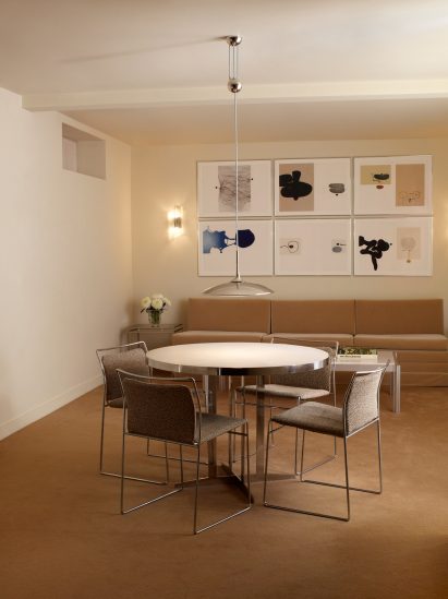 Four chairs around a carpeted floor