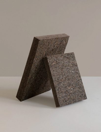 Photo of two panels of Søuld, an acoustic product made from eelgrass, leaning against each other