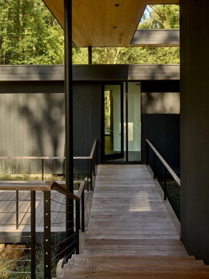 Black wood-clad walls at home by Robert Young Architects