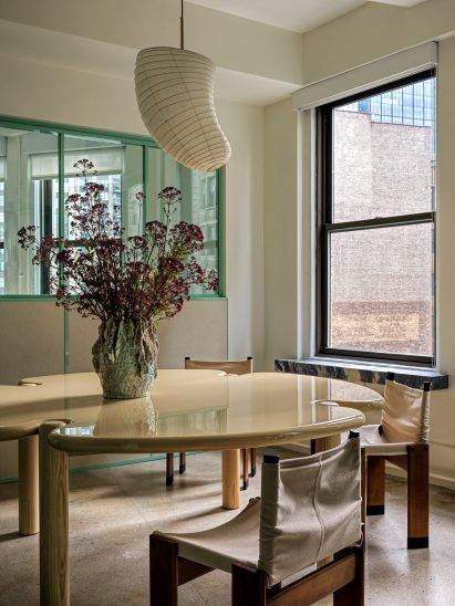 Meeting room with table featuring ash legs and a white lacquered top