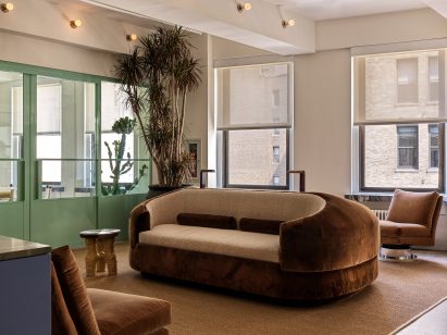 A custom, double-sided sofa upholstered in velvet and boucle fabric