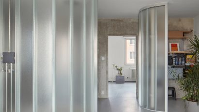 Neuhäusl Hunal renovate apartment in Prague using curved glass walls