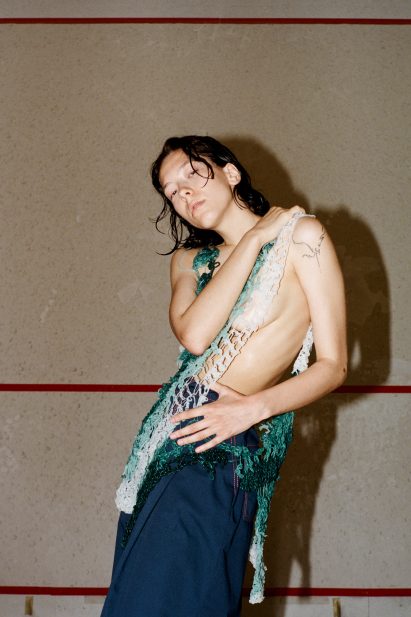 Standing model wears blue and green seaweed-like garment