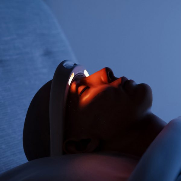 Figure wearing headgear with light shining on eyes