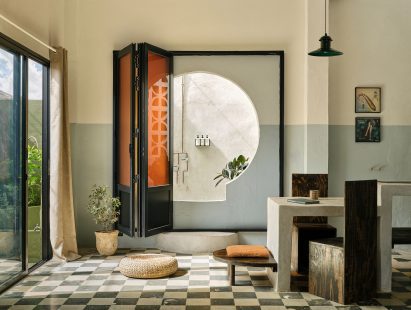 Studio apartment with giant keyhole that leads to an outdoor shower