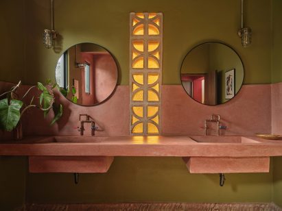 Bathroom featuring olive green walls and a pink vanity and shower