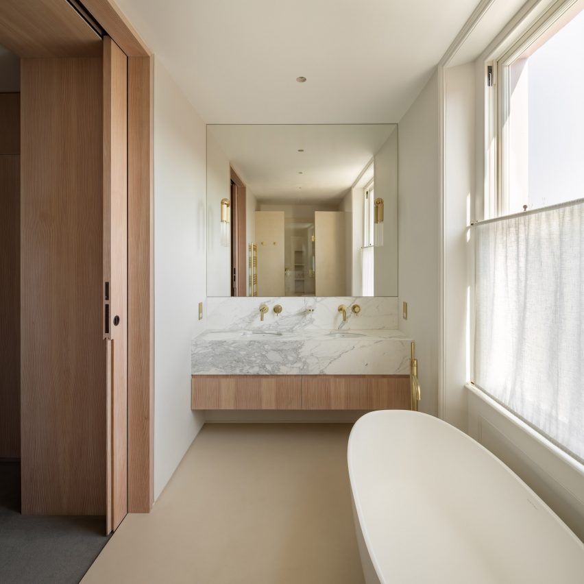 Bathroom with white marble surfaces by Will Gamble Architects
