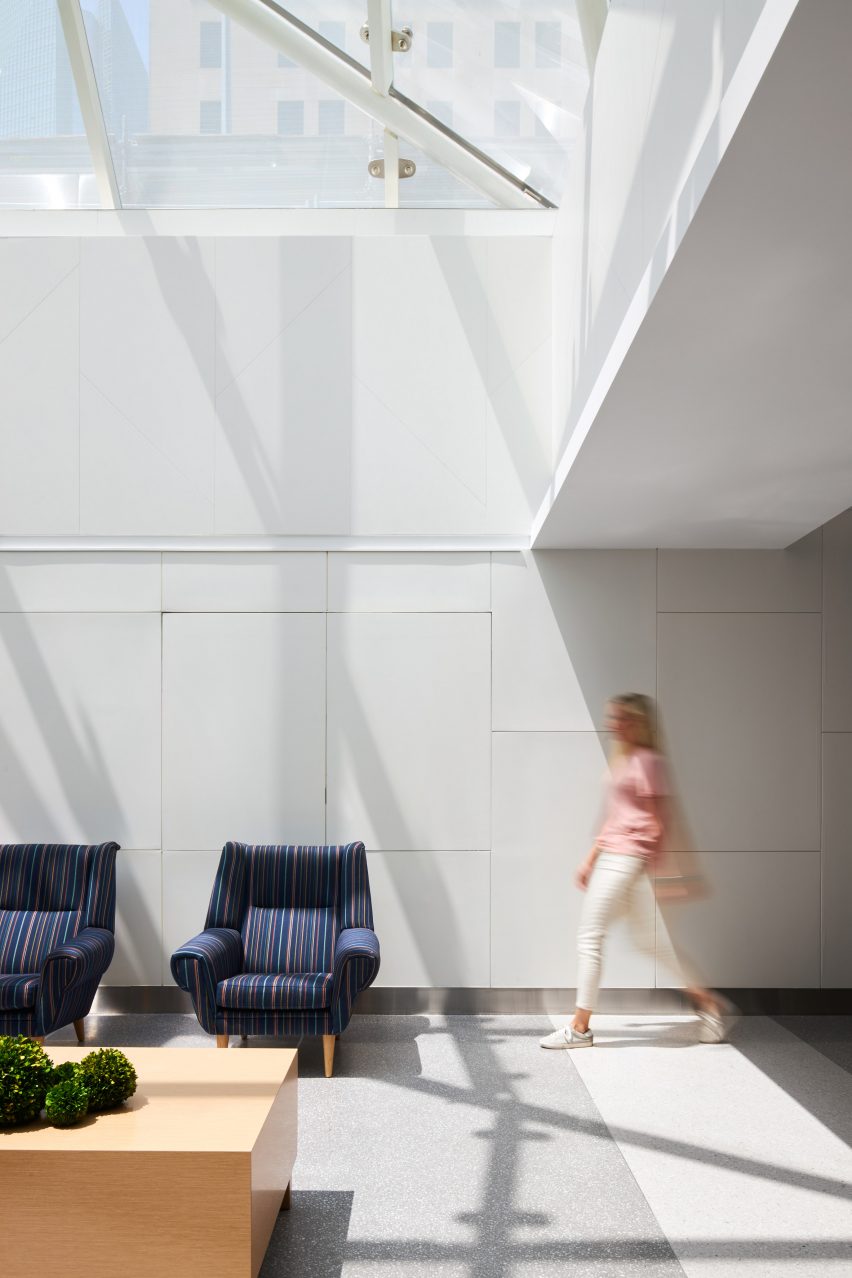 a woman walking by navy blue chairs