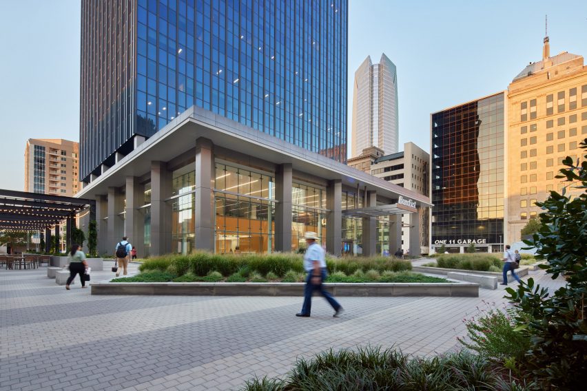 a courtyard surrounding a skyscraper