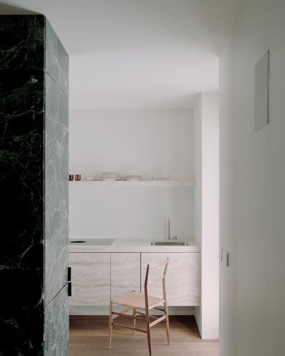 Suspended kitchen system inside Green Nest Apartment by AIM Studio in Milan