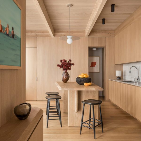Wood-lined kitchen interior with floor-to-ceiling cabinets