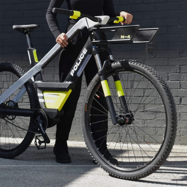 a black e-bile and a man holding the bike; the bike is designed by students at Georgia Institute of Technologies