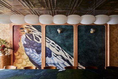 Trio of panels with hand-painted wallpaper displaying bird feathers