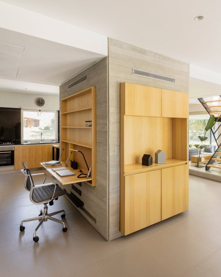 desk and storage around concrete support