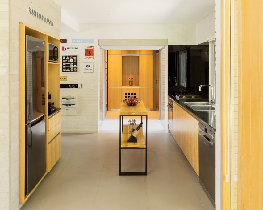 a kitchen with wood cabinets and a small island