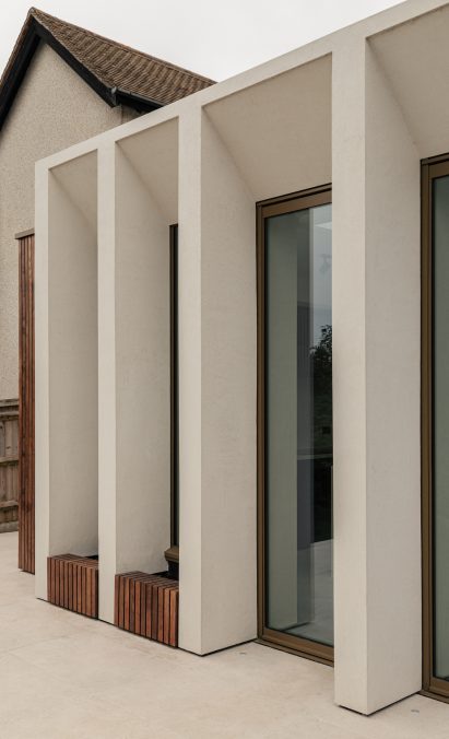 Angled microcement colonnade by Will Gamble Architects in Croydon, London