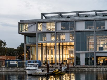 Facade dusk view of concrete maritime academy in Denmark by EFFEKT and CF Moller Architects