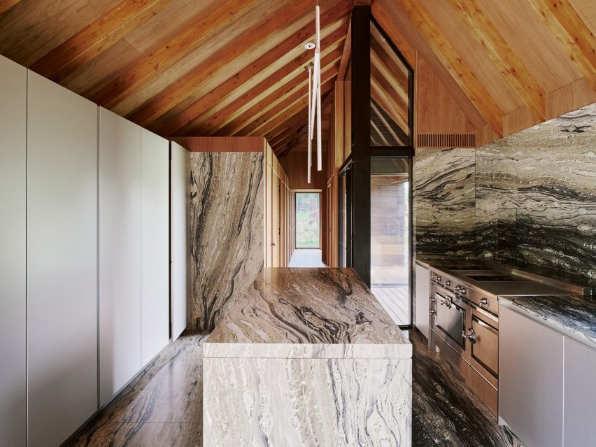 Barn-style kitchen interior with marble surfaces and island