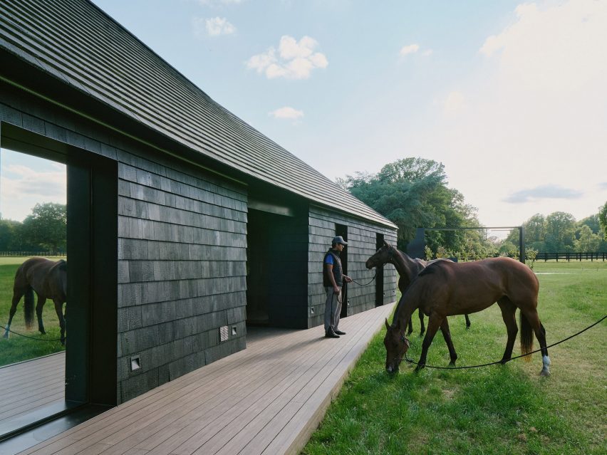 Charred-timber clubhouse in a polo field