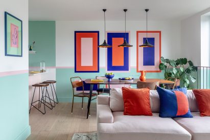 Dining table with colour wall graphics in townhouse by PL Studio
