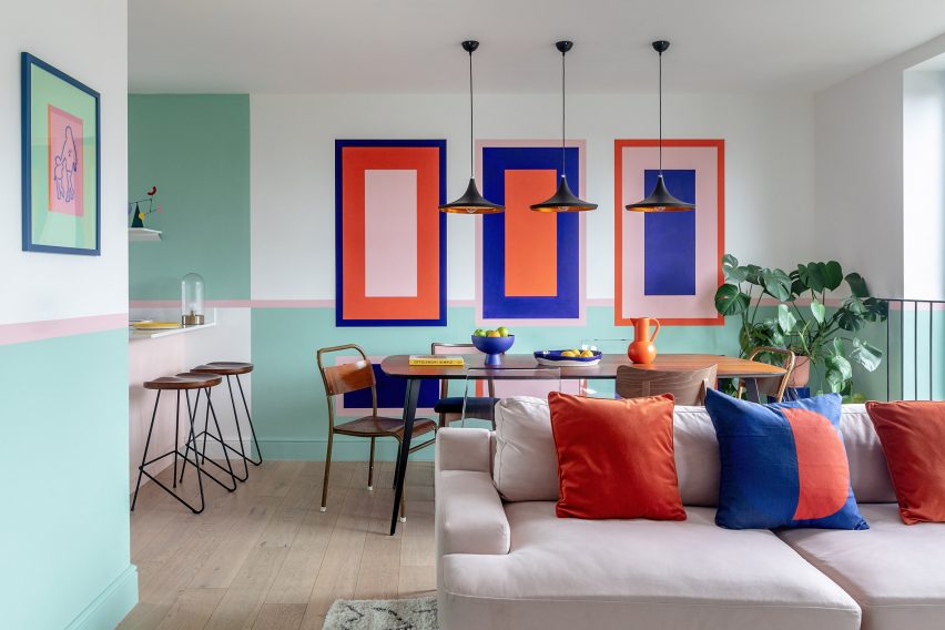 Dining table with colour wall graphics in townhouse by PL Studio