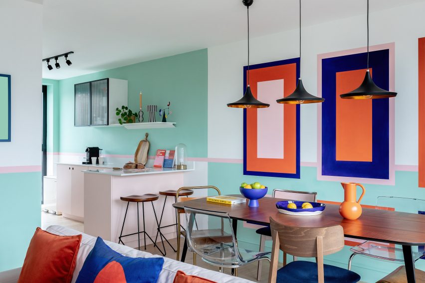 Dining table with colour wall graphics in townhouse by PL Studio