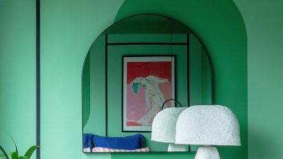 Green wall and arched mirror in Moroccan-inspired townhouse by PL Studio