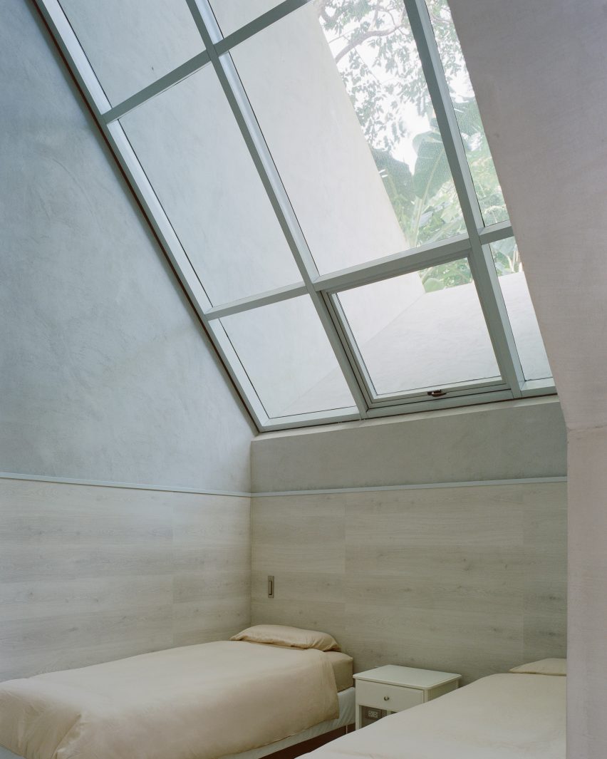 Bedroom with skylight in FR House in the Philippines by CAZA