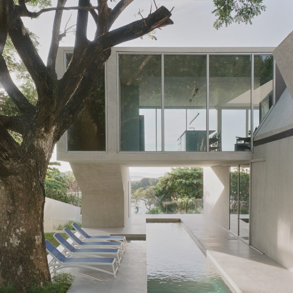 Glazed upper floor oversails swimming pool in FR House in the Philippines by CAZA