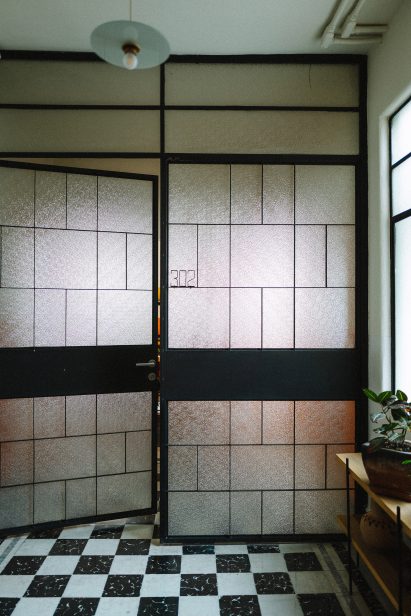 French doors with black and white tile flooring