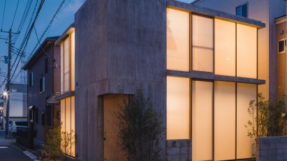 Exterior of compact Japanese house with translucent glazing