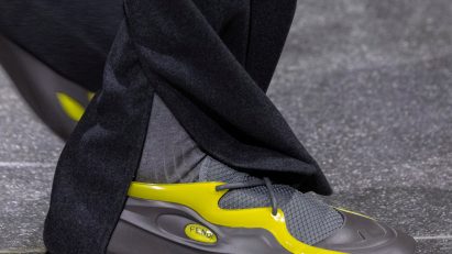 Close-up of model wearing grey-and-yellow trainers designed by Ma Yansong of MAD Architects for Fendi