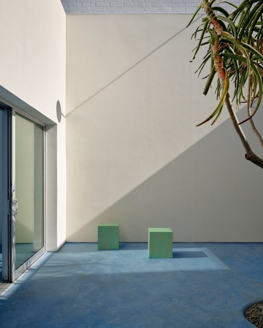 small light green stools in a courtyard