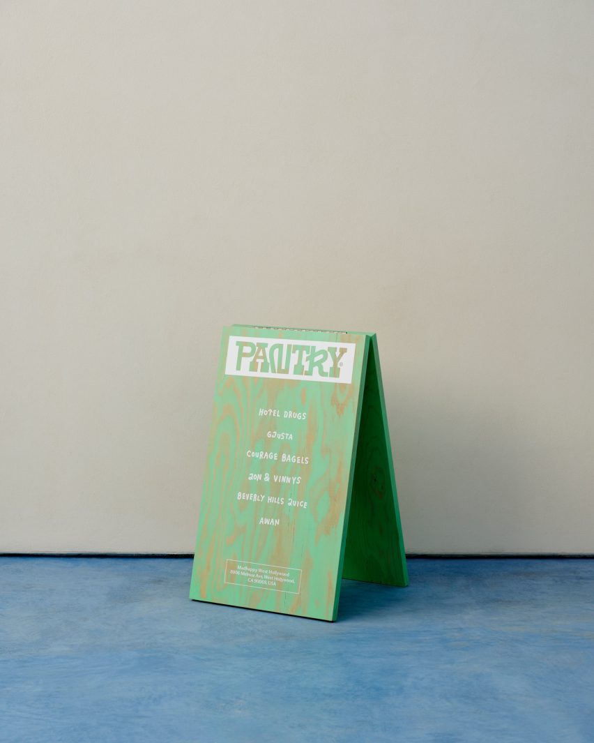 a green plywood sign