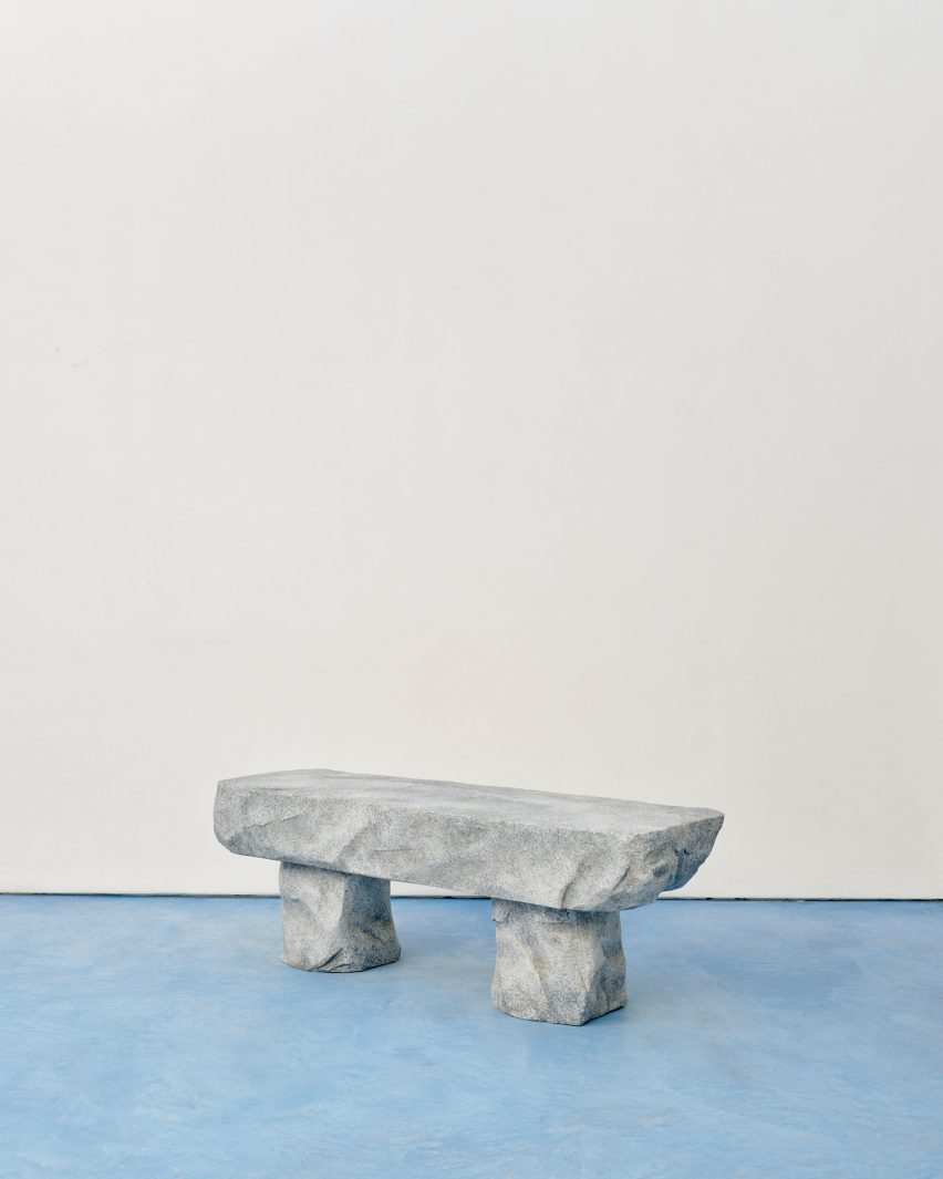 a gray stone bench