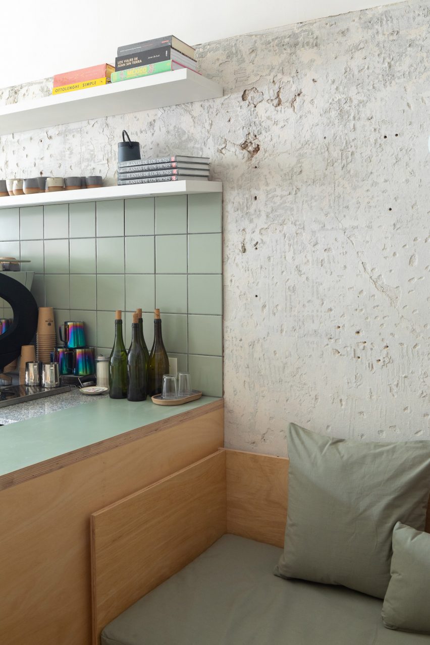 A cafe bar with seafoam green tiles and formica veneer