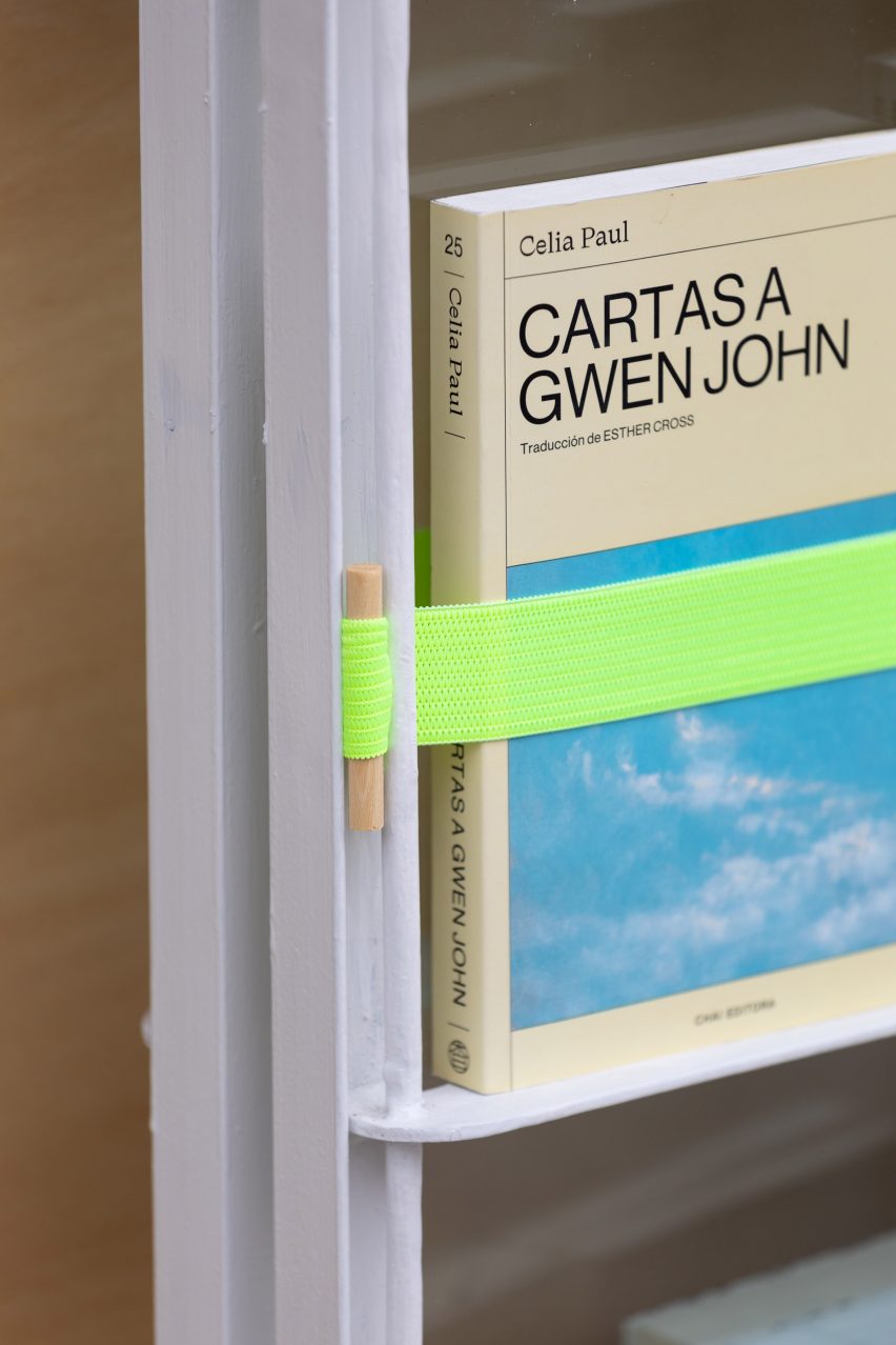 A book bound in place with green elastic