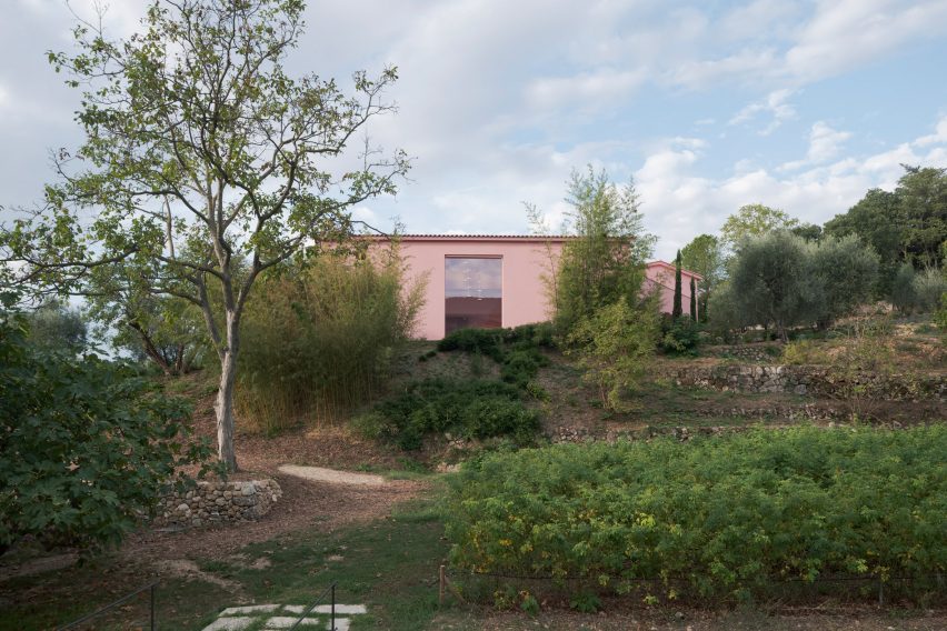 Pink building on a French hillside by Nem Architectes