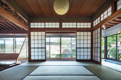Communal space within renovated Japanese home by NYAWA